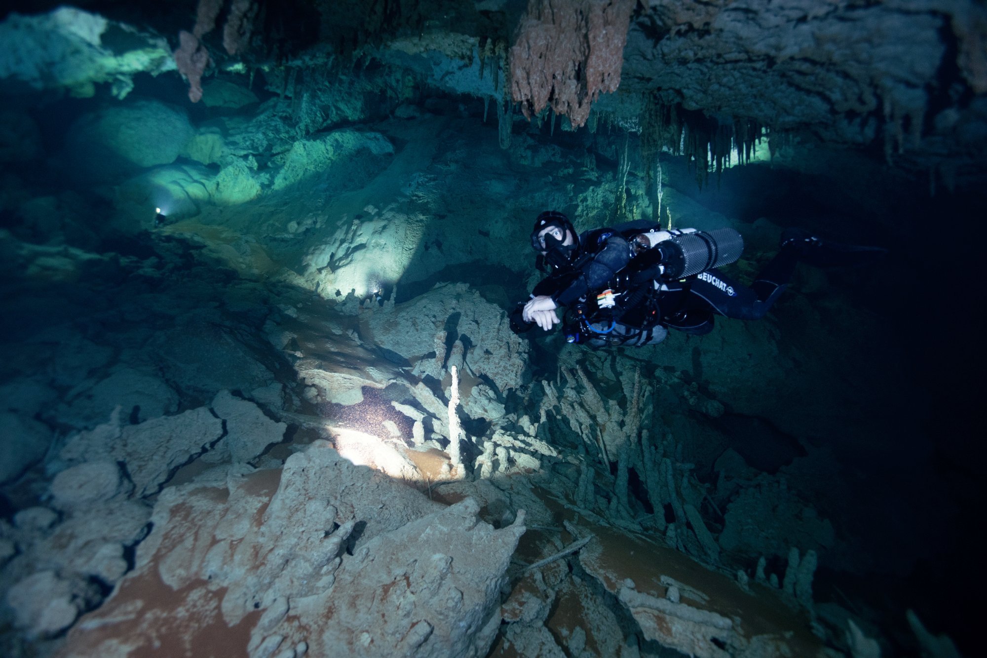 Shannon 'Mick' Micallef cave diving in Giant Cave wearing a top hat
